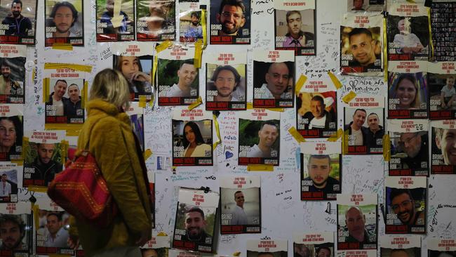 A woman looks at portraits of Israeli hostages held in Gaza since the October 7 attacks by Hamas. Picture: Ahmad Gharabli/AFP