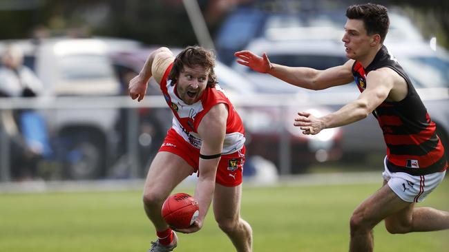 Clarence's Jeromey Webberley evades the tackle of Lauderdale's Adrian Kalcovski. Picture: ZAK SIMMONDS