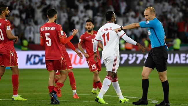 The referee points to the spot to give UAE a lifeline in the Asian Cup opener.