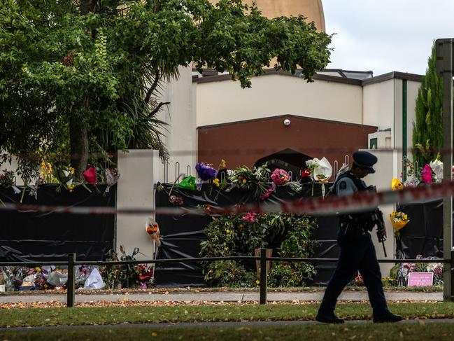  An armed policeman patrols past Al Noor mosque.  The attack was the worst mass shooting in New Zealand's history. Picture: Getty 