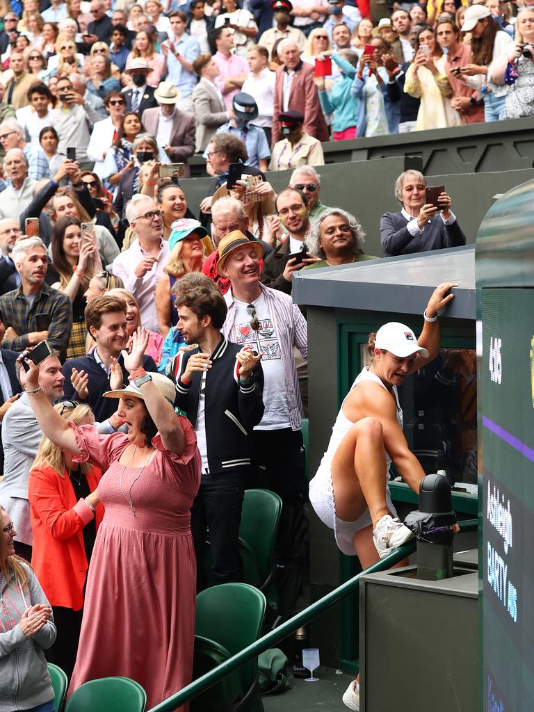 Barty climbs up to see her team after winning the final. Picture: Julian Finney/Getty Images