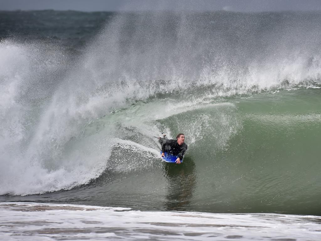 MANLY DAILY/AAP. Big surf proved too tempting for a bodyboarder at Collaroy Beach on Tuesday, June 4. Big seas, strong winds and rain lashed the East Coast of NSW today. AAP IMAGE / Troy Snook)