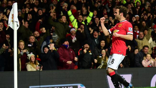 Manchester United's Spanish midfielder Juan Mata celebrates scoring their second goal during the English Premier League football match between Manchester United and Stoke City at Old Trafford in Manchester, north west England, on December 2, 2014. Manchester United won the game 2-1. AFP PHOTO / PAUL ELLIS RESTRICTED TO EDITORIAL USE. No use with unauthorized audio, video, data, fixture lists, club/league logos or “live” services. Online in-match use limited to 45 images, no video emulation. No use in betting, games or single club/league/player publications.