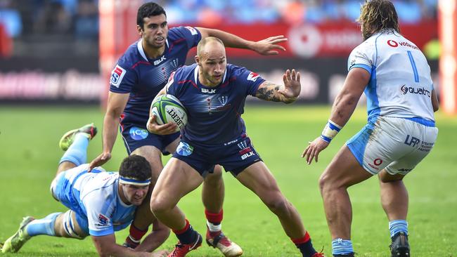 Rebels' Billy Meakes (2nd R) runs as Bulls' Marco van Staden (L) dives to tackle him during the Super Rugby rugby union match between South Africa's Bulls and Australia's Rebels this month.