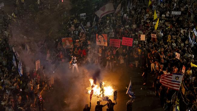 Families of hostages and supporters set a fire and use smoke torches during a rally calling for an immediate hostage deal with Hamas and against the Israeli Prime Minister Benjamin Netanyahu and his government on September 7, 2024 in Tel Aviv. Picture: Getty