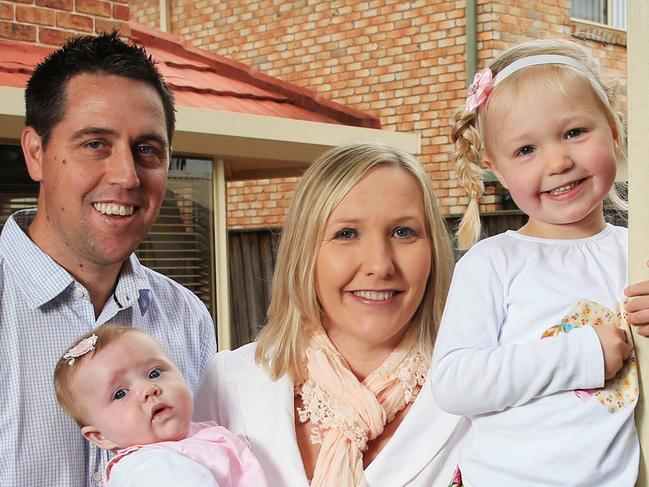 The Blackman family pictured at their Kellyville home, dad Andrew, mum Nerilee and kids Charlotte 3 and Amy 5 months. Picture: Toby Zerna