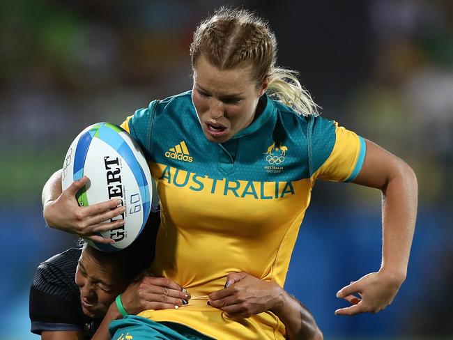 Emma Tonegato of Australia breaks through to score a try.