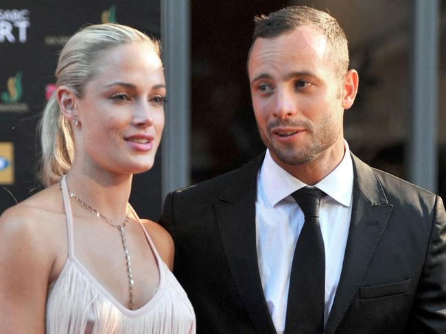 (FILES) In this file photo taken on November 04, 2012 during the Feather Awards held at Melrose Arch in Johannesburg shows South Africa's Olympic sprint star Oscar Pistorius and his model girlfriend Reeva Steenkamp. - South African Paralympic champion Oscar Pistorius might be released from prison this week, a decade after he killed his girlfriend in a crime that gripped the world.  A parole board is to decide whether Pistorius should be let out early, after a hearing in Pretoria on March 31, 2023. (Photo by LUCKY NXUMALO / AFP)