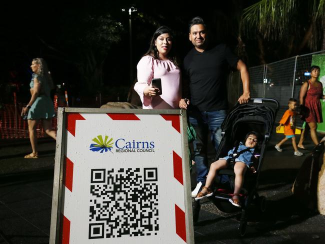 Mia Bassan, Garry Bassan and Ajunie Bassan, 18 months, register their attendance at the New Year's Eve on the Cairns Esplanade using the QR code. Picture: Brendan Radke