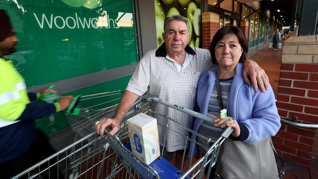 Tony and Gina Guccione leave Woolworths in Moonee Ponds with a few items including a box of tissues after not being able to purchase toilet paper. Picture: David Geraghty