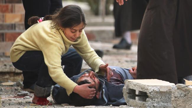 An Iraqi girl cries over her father's body in the Al-Risala neighbourhood in Mosul.