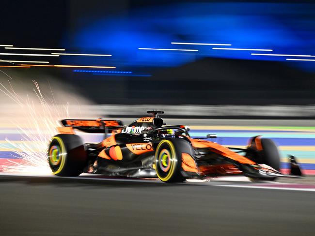 LUSAIL CITY, QATAR - NOVEMBER 29: Sparks fly behind Oscar Piastri of Australia driving the (81) McLaren MCL38 Mercedes during Sprint Qualifying ahead of the F1 Grand Prix of Qatar at Lusail International Circuit on November 29, 2024 in Lusail City, Qatar. (Photo by Clive Mason/Getty Images)