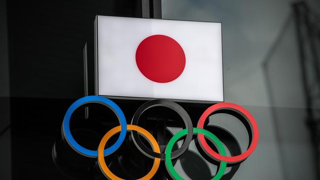 TOKYO, JAPAN - OCTOBER 13: The Japanese flag is displayed over the Olympic Rings on October 13, 2020 in Tokyo, Japan. Despite assurances from senior International Olympic Committee and Japanese government officials, concerns remain over whether or not the postponed Tokyo Olympics will go ahead even in 2021 as the Covid-19 coronavirus pandemic continues to cause major disruption across the globe. (Photo by Carl Court/Getty Images)