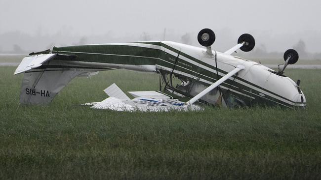 A plane flipped at Bowen Airport, Queensland, Wednesday, March 29, 2017. The coastal Queensland town of Bowen has found itself largely intact in the wake of Tropical Cyclone Debbie. (AAP Image/Sarah Motherwell) NO ARCHIVING