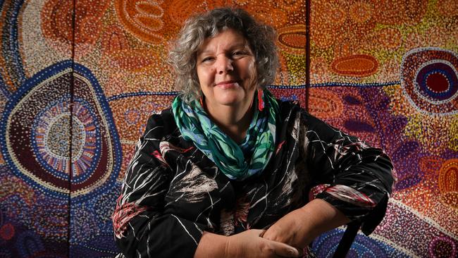 Tarnanthi Festival artistic director Nici Cumpston in front of the triptych painting Antara by Ngupulya Pumani from Mimili Maku Arts. Picture: Tricia Watkinson