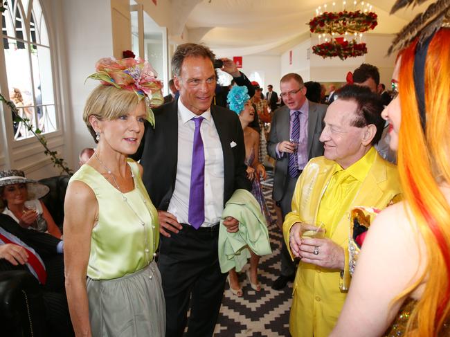 Julie Bishop and her partner David Panton talk to Geoffrey Edelsten and Gabi Grecko in the Emirates marquee in the Birdcage at Flemington Racecourse during the Melbourne Cup.