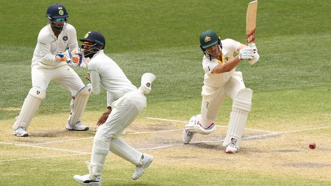 Pat Cummins drives during Australia’s second innings in Adelaide. Picture: Getty Images