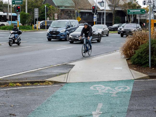 A cyclist rides their bicycle in the car lane instead of the shared path linking Centennial Park with the cycle lane on Moore Park Rd, at Paddington. Picture: Max Mason-Hubers