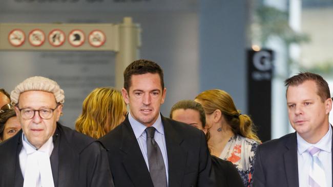 Former soldier Christopher Carter (centre) leaves the Brisbane Supreme Court with supporters with his lawyer Dave Garratt (right). Picture: AAP