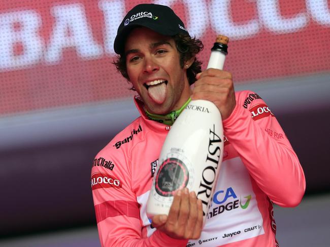 Australian Michael Matthews (Orica-Green Edge) celebrates the pink jersey of the overall leader on the podium of the 2nd stage of the 97th Giro d'Italia, Tour of Italy, cycling race from Belfast to Belfast (219 km) on May 10, 2014 in Belfast. German Marcel Kittel won the stage ahead France's Nacer Bouhanni and Giacomo Nizzolo. AFP PHOTO/LUK BENIES