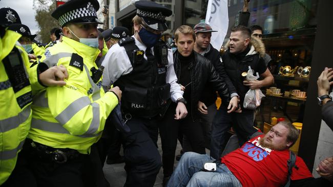 Demonstrators scuffle with Metropolitan Police officers during a StandUpX March for Freedom protest in London, England. They are calling for an end to Coronavirus restrictions. Picture: Getty