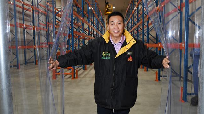 Nelson Lay proudly stands in the new Asian United Food premises after it was burnt to the ground. Picture KATRINA BRIDGEFORD