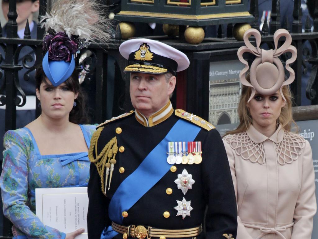 Andrew with daughter Eugenie and Beatrice. Picture: AP Photo/Gero Breloer, FILE