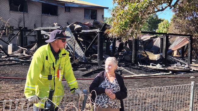 Edington Street resident Eileen Brown chats with a Queensland Fire and Emergency Services worker on Friday, August 11, 2023. Photo: Darryn Nufer.