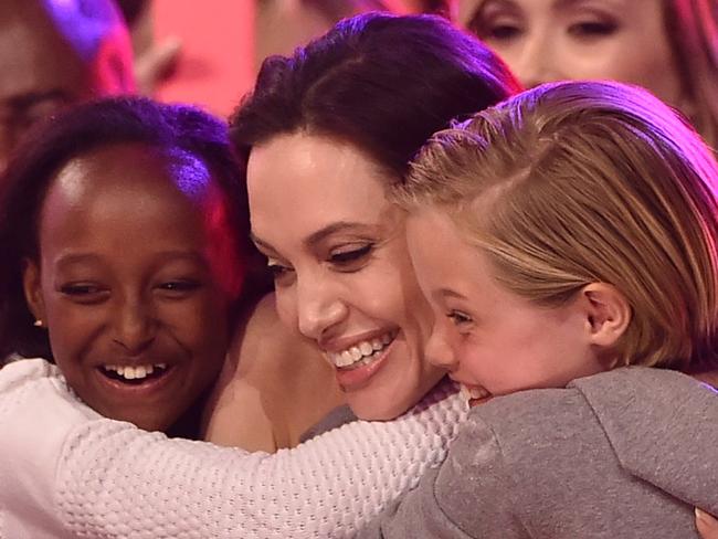 INGLEWOOD, CA - MARCH 28: Actress Angelina Jolie hugs Zahara Marley Jolie-Pitt (L) and Shiloh Nouvel Jolie-Pitt (R) after winning award for Favorite Villain in 'Maleficent' during Nickelodeon's 28th Annual Kids' Choice Awards held at The Forum on March 28, 2015 in Inglewood, California. (Photo by Kevin Winter/Getty Images)