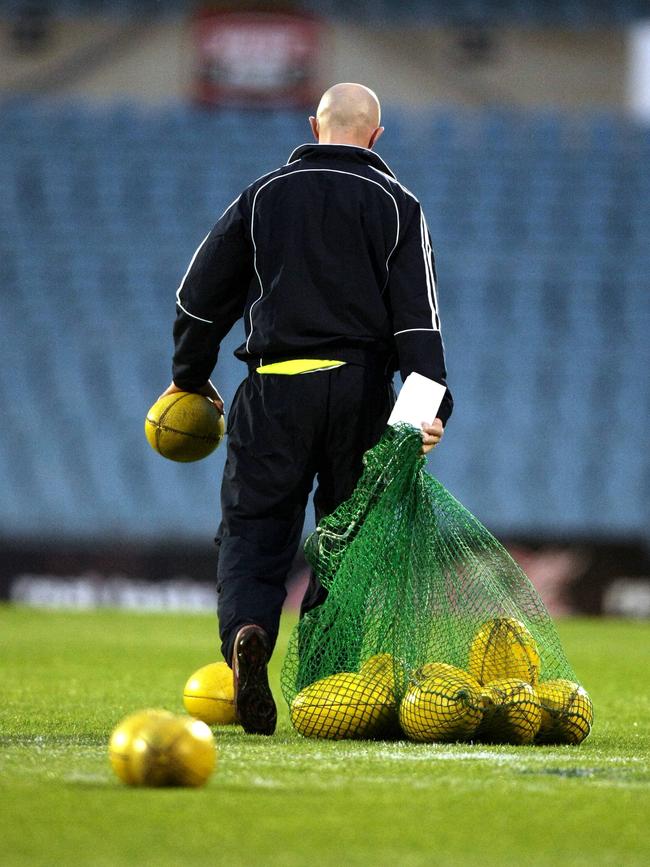 Laird retrieving the footys after training at Football Park.