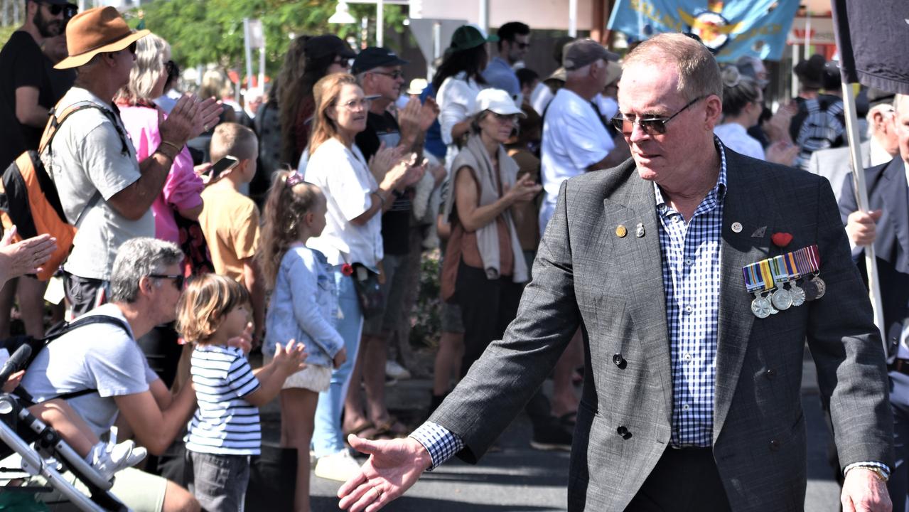 Those in the Ballina Anzac Day March 2022 greet children clapping. Picture: Tessa Flemming