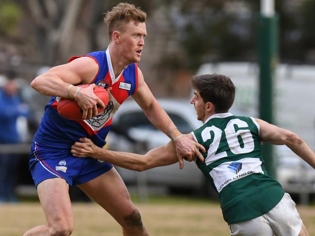 Liam Hunt shrugging a tackle for North Heidelberg. Picture: Nathan McNeill.