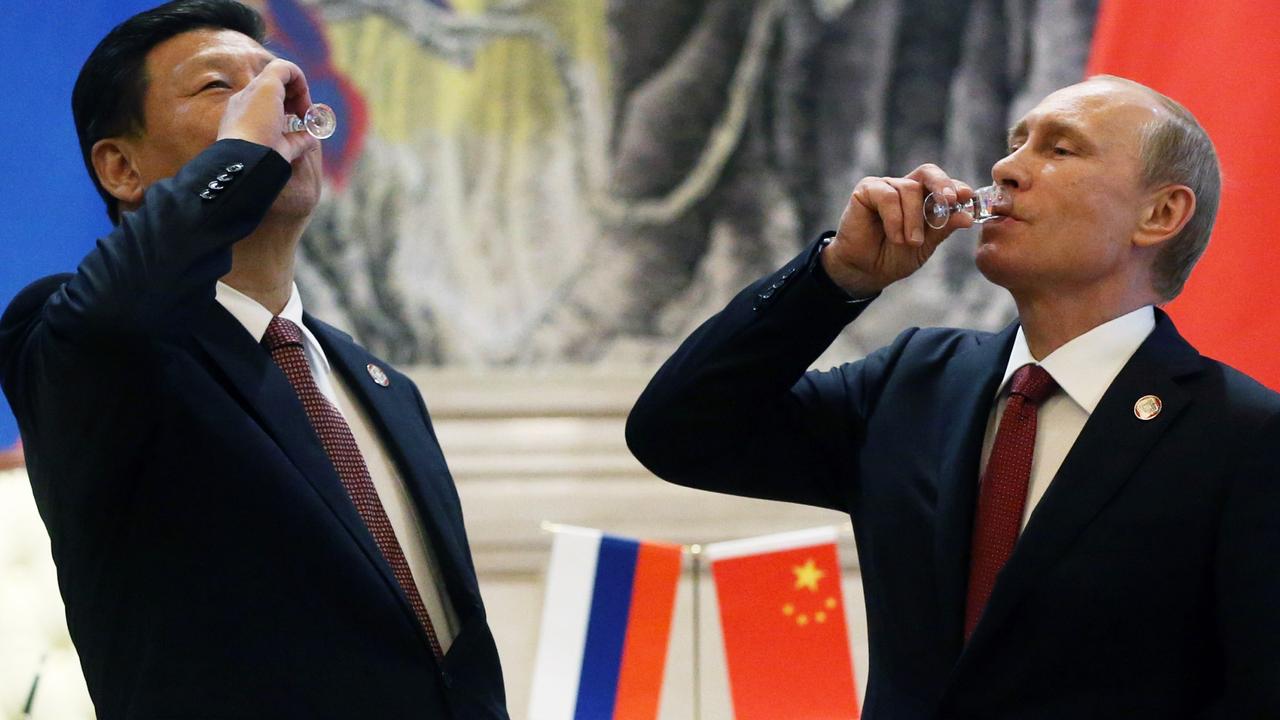 President of Russia Vladimir Putin and Chinese President Xi Jinping toast with vodka during a signing ceremony on May 21, 2014 in Shanghai, China. Picture: Sasha Mordovets/Getty Images.