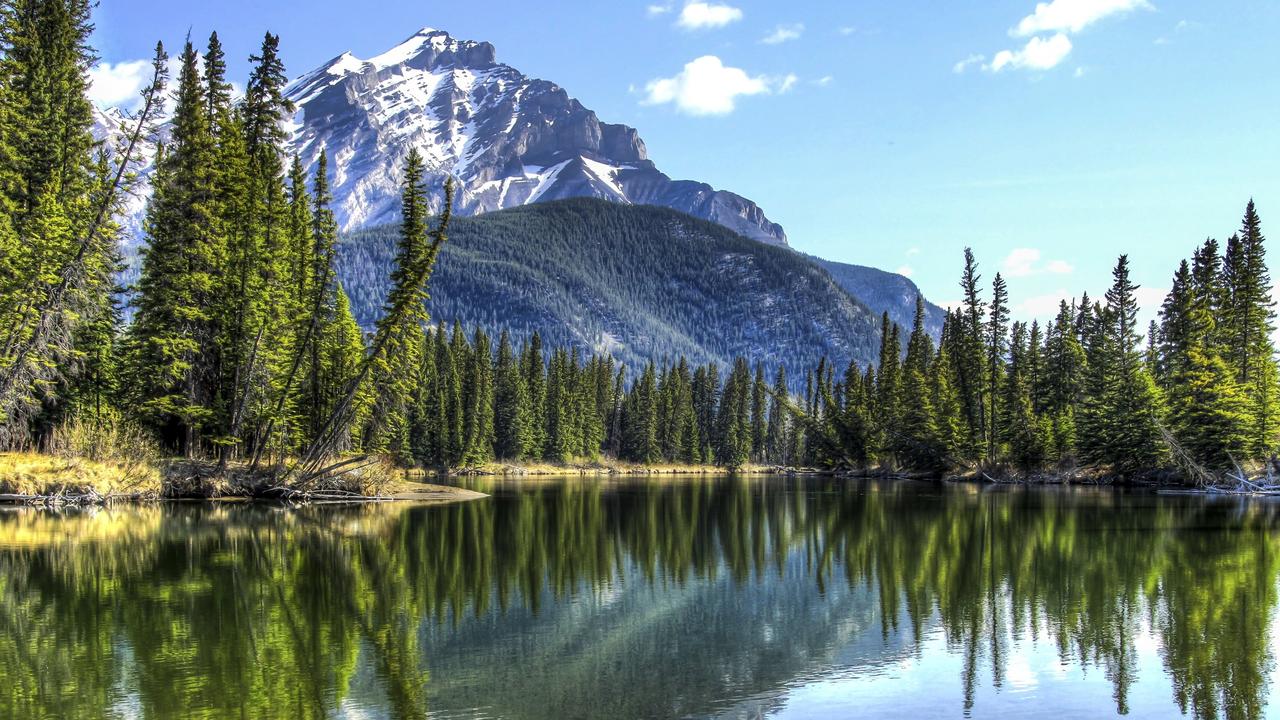 Cascade Mountain reflecting in the Bow River in Banff National Park, Alberta, Canada.