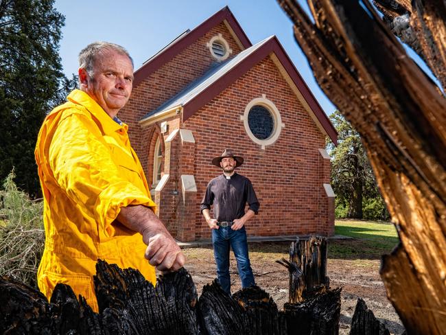 The Holy Trinity church in Cudgewa saved by  firey. Fire came close but didn't burn down the church.  Cudgewa CFA captain Paul Carkeek and father Mitchell Porter. Picture: Simon Dallinger