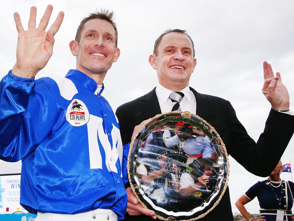 Jockey Hugh Bowman and trainer Chris Waller pose with the Cox Plate.