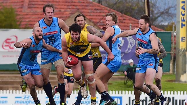 Jarrad Redden tries to escape the Sturt pack at Woodville Oval. Picture: Bianca De Marchi