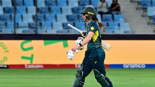 Australia's Georgia Wareham walks back to the pavilion after her dismissal during the ICC Women's T20 World Cup cricket semi-final match between Australia and South Africa at the Dubai International Cricket Stadium in Dubai on October 17, 2024. (Photo by Giuseppe CACACE / AFP)