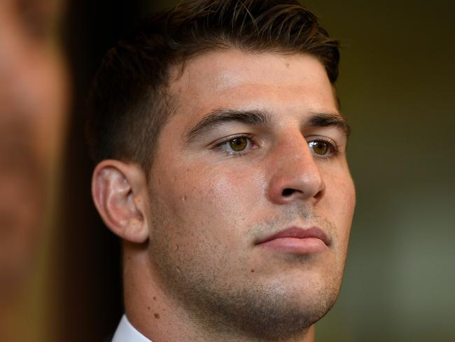 NRL player Curtis Scott (centre) leaves the Downing Centre Local Court in Sydney, Friday, January 31, 2020. Canberra Raiders NRL recruit Curtis Scott has pleaded not guilty to six charges including assaulting police during Australia Day celebrations. (AAP Image/Bianca De Marchi) NO ARCHIVING