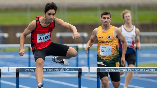 Julian Lee from Marsfield in the lead in the 400m hurdles final.