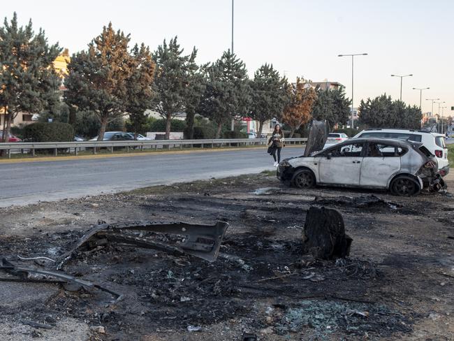 The scene a few hours after the car-bombing which seriously injured Jay Malkoun. His Mercedes was taken away but other burned cars remained at the scene on Vouliagmenis Avenue, Glyfada. Picture: Supplied 