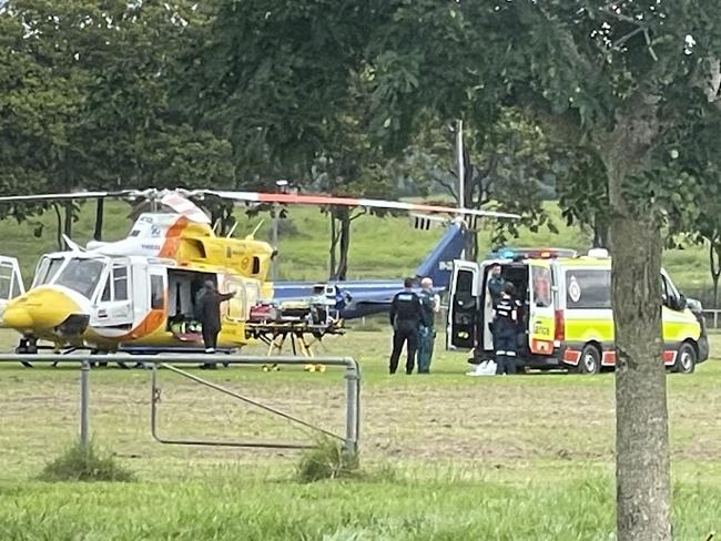 Multiple emergency crews are at the Sarina showgrounds, trying to save a man in his 20s who was seriously injured in a nearby Bruce Hwy crash.