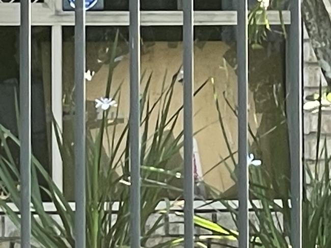 A shattered front window at the Upper Coomera home where it's understood the confrontation took place. Picture: Supplied.