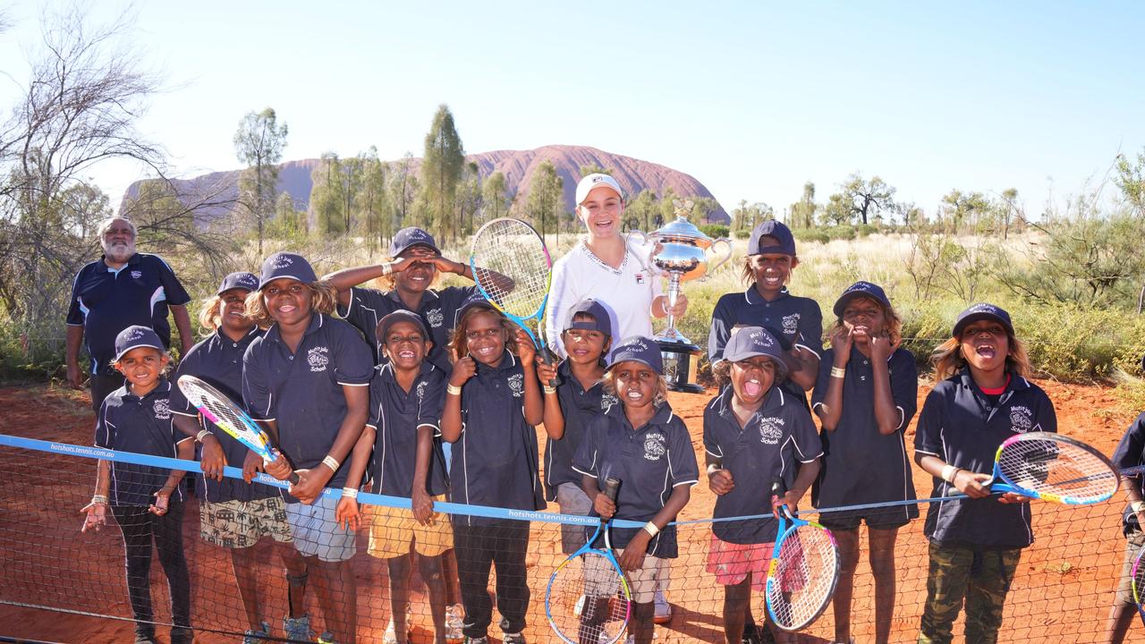 Barty was awarded the National Dreamtime Award, celebrating Australian Aboriginal and Torres Strait Islander achievement in sport, in 2017, 2018 and 2019. Here she poses with Mutitjulu school students in Uluru-Kata Tjuta National Park in February 2022. Picture: Scott Barbour/Tennis Australia.