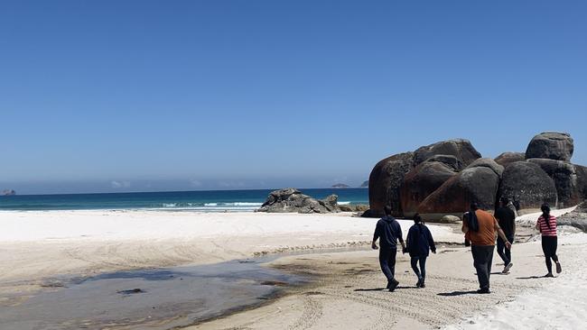 Family and close friends walk Squeaky Beach on Boxing Day