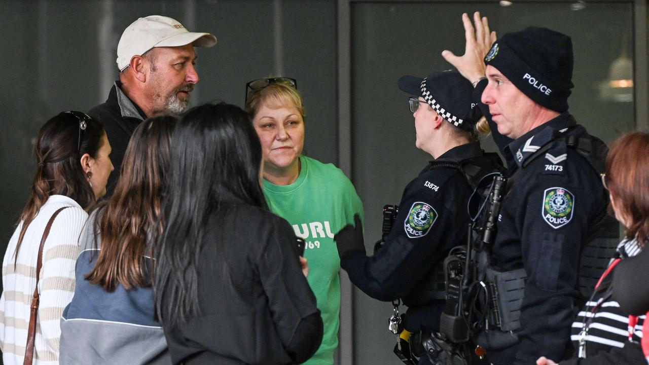 Police talk to concerned parents whose children are locked down in the Westfield Marion where armed gangs were reported inside. Picture: NewsWire / Brenton Edwards