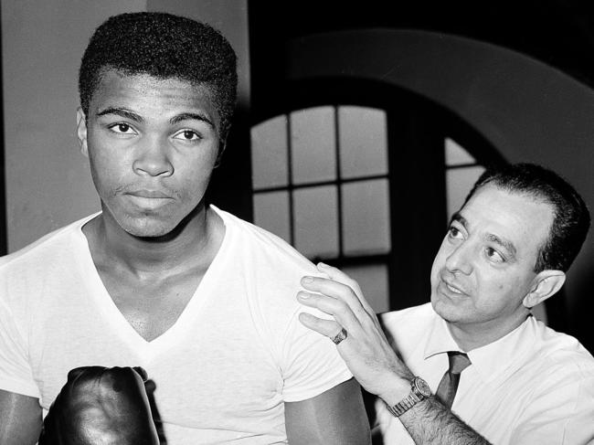 Young boxer Cassius Clay (L), who later changed his name to Muhammad Ali, stands with his trainer Angelo Dundee at City Parks Gym in New York in 08/02/1962. Dundee, the trainer who helped groom Ali to become multiple world heavyweight champion and Sugar Ray Leonard as a world champion, died 01/02/2012 at his Tampa, Florida home aged 90.