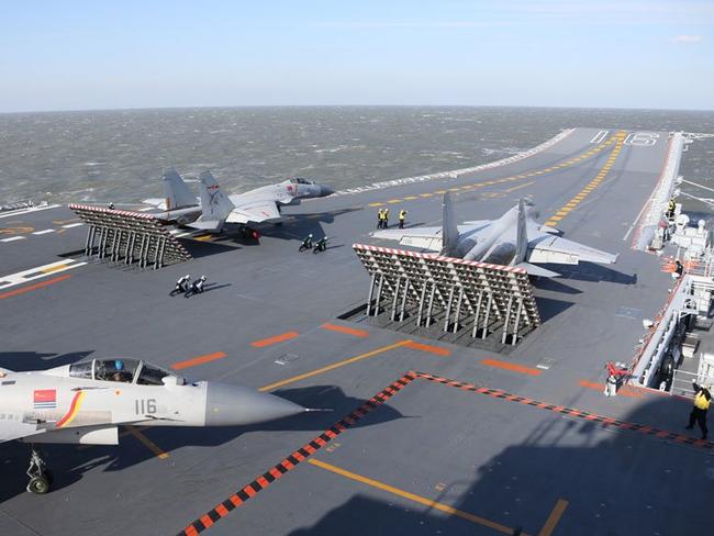 Fighters move into position for launch aboard China's first aircraft carrier, Liaoning. Picture: Xinhua