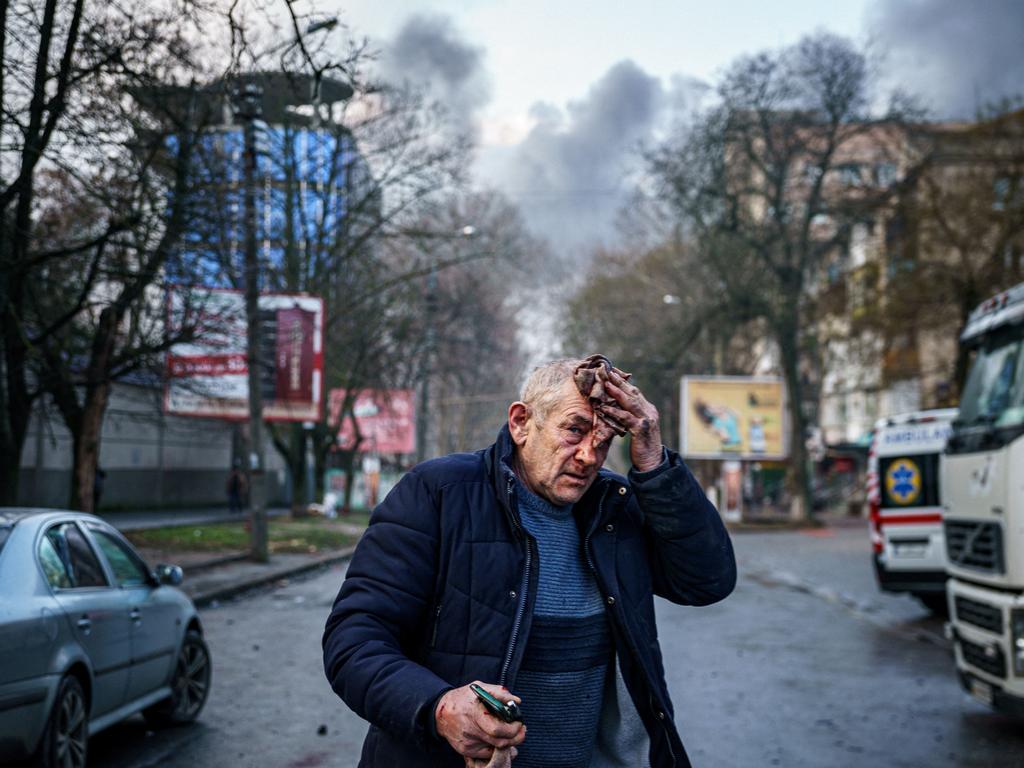 An injured man stands on a street after Russian shelling to Ukrainian city of Kherson on Christmas Eve. Picture: AFP