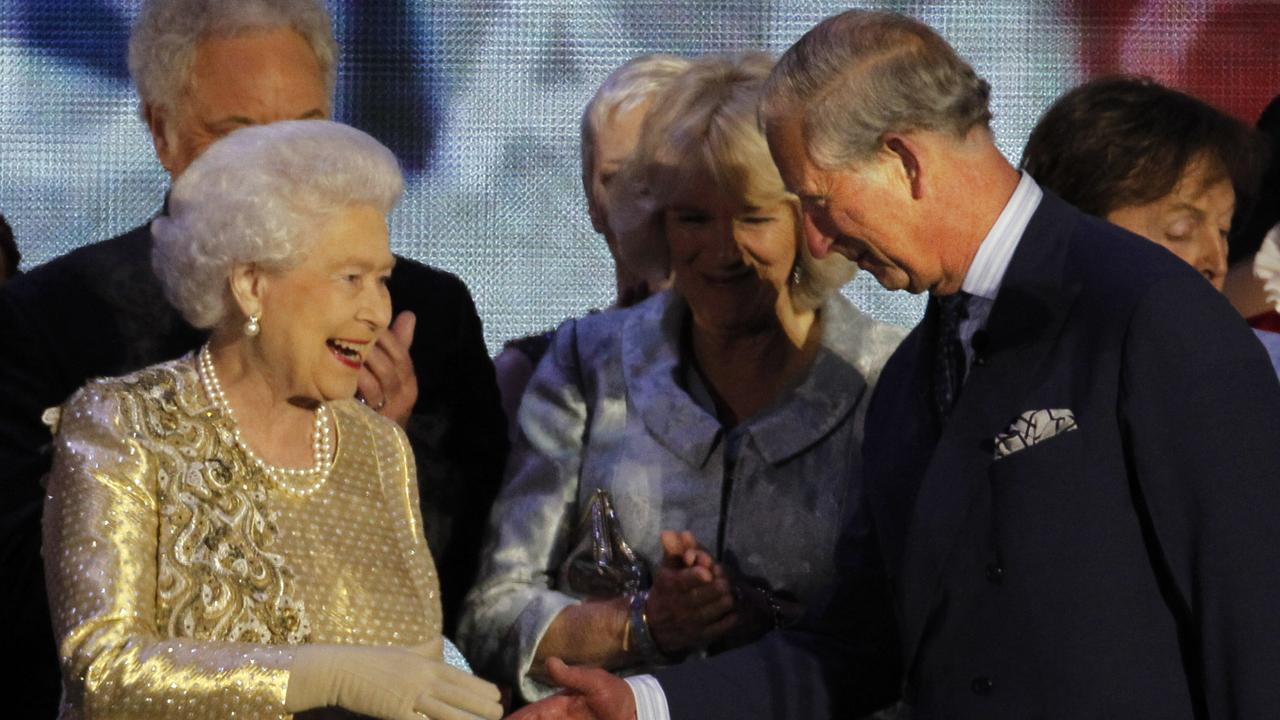 Queen Elizabeth II shakes the hand of her son Prince Charles at the end of the Queen's Jubilee Concert in front of Buckingham Palace, London. Picture: AP